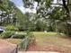 Sprawling backyard with mature trees, storage shed, and play equipment, perfect for Gathering enjoyment at 3970 Norman Rd, Stone Mountain, GA 30083