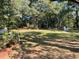 Expansive backyard with lush greenery, including mature trees and a quaint storage shed, offers privacy at 3970 Norman Rd, Stone Mountain, GA 30083