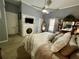 Spacious bedroom features a ceiling fan, fireplace with TV, and large bed at 3970 Norman Rd, Stone Mountain, GA 30083