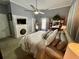 Bright bedroom boasts a ceiling fan, decorative fireplace with TV, and large bed at 3970 Norman Rd, Stone Mountain, GA 30083