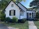 Charming white home with black trim, a screened porch, and manicured landscaping at 3970 Norman Rd, Stone Mountain, GA 30083