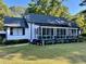 Charming home with black shutters, a screened porch, and freshly manicured lawn at 3970 Norman Rd, Stone Mountain, GA 30083