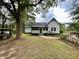 Charming home with dark shutters viewed from the spacious, green front yard at 3970 Norman Rd, Stone Mountain, GA 30083