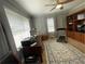 Well-lit home office with shelving units, a ceiling fan, and a dedicated workspace at 3970 Norman Rd, Stone Mountain, GA 30083