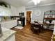 Charming kitchen with stainless steel appliances, wood floors, and bright, white cabinets at 3970 Norman Rd, Stone Mountain, GA 30083