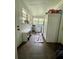 Laundry room with a washer, dryer, refrigerator, storage, and an exterior door at 3970 Norman Rd, Stone Mountain, GA 30083