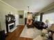 Spacious living room featuring a fireplace, hardwood floors, and an open doorway to the dining area at 3970 Norman Rd, Stone Mountain, GA 30083
