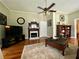 Warm living room with a decorative fireplace, hardwood floors, and comfortable seating arrangement at 3970 Norman Rd, Stone Mountain, GA 30083
