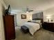 Tranquil main bedroom featuring a ceiling fan, a comfortable bed, and soft lighting at 3970 Norman Rd, Stone Mountain, GA 30083