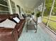Inviting screened porch with comfortable seating, stylish rug, and a serene outdoor view at 3970 Norman Rd, Stone Mountain, GA 30083