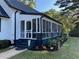 Charming home showcasing a screened porch with black painted steps, perfect for outdoor living and entertaining at 3970 Norman Rd, Stone Mountain, GA 30083