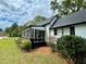 Exterior view of a home with a lovely screened porch and meticulously landscaped yard, great for relaxing at 3970 Norman Rd, Stone Mountain, GA 30083
