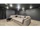 Finished basement with a sectional sofa, projector, and media screen at 1995 Woodmont Dr, Douglasville, GA 30135