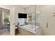 Modern bathroom featuring a soaking tub, glass shower, and mounted TV at 1995 Woodmont Dr, Douglasville, GA 30135