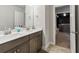 Well-lit bathroom boasts a double vanity with white countertops and neutral-toned cabinetry at 1995 Woodmont Dr, Douglasville, GA 30135