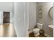Stylish powder room with modern fixtures, decorative mirror, and elegant wall decor at 1995 Woodmont Dr, Douglasville, GA 30135