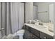 Bathroom featuring a gray vanity, modern fixtures, and a shower with a stylish patterned curtain at 1995 Woodmont Dr, Douglasville, GA 30135