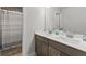 Bathroom featuring double sinks, and a tub shower with a striped curtain at 1995 Woodmont Dr, Douglasville, GA 30135