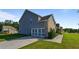 Two-story home showcasing a gray siding, a brick facade, and a well-manicured front lawn at 1995 Woodmont Dr, Douglasville, GA 30135