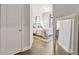Hallway view into bedroom with wood floors, and a large mirror at 1995 Woodmont Dr, Douglasville, GA 30135