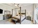 Spacious main bedroom with a four-poster bed, dresser, mirror, and abundant natural light at 1995 Woodmont Dr, Douglasville, GA 30135
