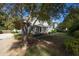 A quaint property showcases a lovely covered porch and verdant lawn shaded by mature trees at 150 E Main St, Rutledge, GA 30663