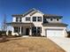 Charming two-story home with a painted brick facade, dark shutters, and a well-manicured lawn at 6200 Misty Hill Ln, Buford, GA 30518