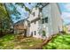 Exterior view showing the backyard, a wooden deck, lush lawn, and the home's modern siding at 6462 Beaver Creek Trl, Atlanta, GA 30349
