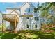 Backyard with green grass, tree line, and view of the deck on the back of the home at 6462 Beaver Creek Trl, Atlanta, GA 30349