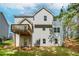 A view of the back of the home and the wooden deck overlooking the backyard with lush green grass at 6462 Beaver Creek Trl, Atlanta, GA 30349