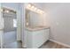 Elegant bathroom vanity with double sinks, granite countertop, and decorative lighting at 6462 Beaver Creek Trl, Atlanta, GA 30349