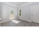 Well-lit bedroom featuring gray wood flooring and access to a deck through a glass door at 6462 Beaver Creek Trl, Atlanta, GA 30349