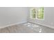 Bright bedroom with modern flooring, neutral walls, and a large window at 6462 Beaver Creek Trl, Atlanta, GA 30349