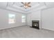 Spacious bedroom with tray ceiling, fireplace, and lots of natural light at 6462 Beaver Creek Trl, Atlanta, GA 30349