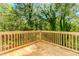 Wooden deck overlooking a backyard surrounded by lush greenery and trees at 6462 Beaver Creek Trl, Atlanta, GA 30349