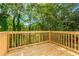 Spacious wooden deck providing serene views of the surrounding greenery and trees at 6462 Beaver Creek Trl, Atlanta, GA 30349