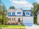 Charming two-story home with a covered front porch and a well-manicured lawn at 6462 Beaver Creek Trl, Atlanta, GA 30349