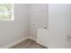 Small laundry room with wire shelf storage, and gray wood flooring at 6462 Beaver Creek Trl, Atlanta, GA 30349