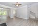Spacious living room featuring modern floors, ceiling fan, and an open layout at 6462 Beaver Creek Trl, Atlanta, GA 30349