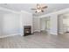 Bright living room featuring a fireplace, modern flooring, and a ceiling fan at 6462 Beaver Creek Trl, Atlanta, GA 30349