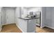Stylish kitchen with stainless steel appliances, white cabinets, and a breakfast bar with a black countertop at 2700 Pine Tree Ne Rd # 1007, Atlanta, GA 30324