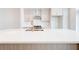 Close up on a spacious kitchen island with a sink and white countertop at 1239 Chelsea Nw Cir, Atlanta, GA 30318