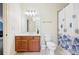 Bathroom features a shower with curtain, tile flooring, and a vanity with wooden drawers, offering a practical space at 3127 Lenox Road # 6, Atlanta, GA 30324