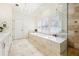 Bathroom featuring a tub, shutters, a shower, and a chandelier at 3127 Lenox Road # 6, Atlanta, GA 30324