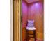 Private elevator with wood paneling, a stool, and purple ambient lighting creates a luxurious and comfortable experience at 3127 Lenox Road # 6, Atlanta, GA 30324