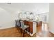 Bright kitchen featuring an island, a breakfast bar with seating, hardwood floors, and white cabinetry at 3127 Lenox Road # 6, Atlanta, GA 30324