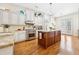 Well-lit kitchen with a large center island, granite countertops, stainless steel appliances, and hardwood floors at 3127 Lenox Road # 6, Atlanta, GA 30324