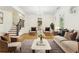 Bright living room featuring hardwood floors, staircase, large windows, and elegant chandelier at 3127 Lenox Road # 6, Atlanta, GA 30324