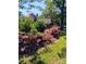 Exterior of home shows flower bushes, covered porch, and lush backyard at 133 Hillside Se Ave, Atlanta, GA 30315
