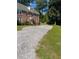 The side of the brick home has a gravel driveway and green lawn at 133 Hillside Se Ave, Atlanta, GA 30315